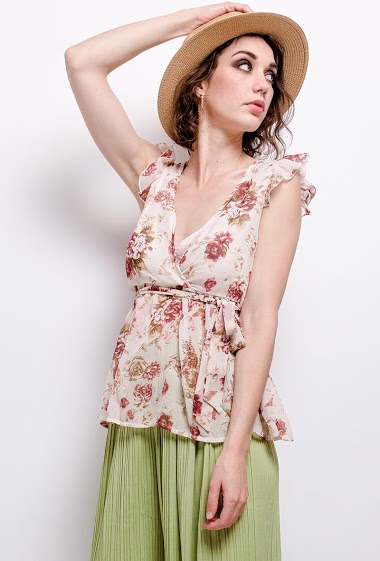 Blouse with printed flowers, ruffles. The model measures 177 cm