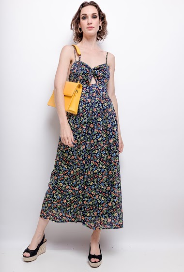 Strappy dress, printed flowers, knot. The model measures 177 cm