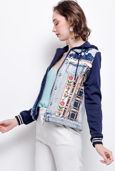 Bi-material jacket with embroidery. The model measures 177cm